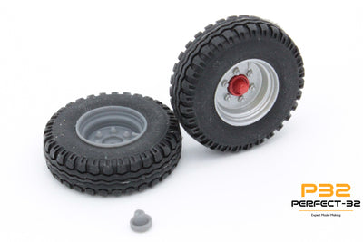 Two black tires with silver rims on a white background