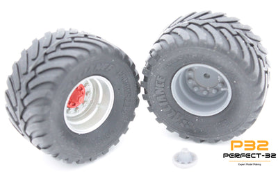 Two gray off-road tires with white centers on a white background