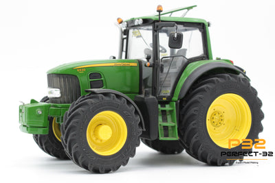 Green tractor with yellow wheels on a white background